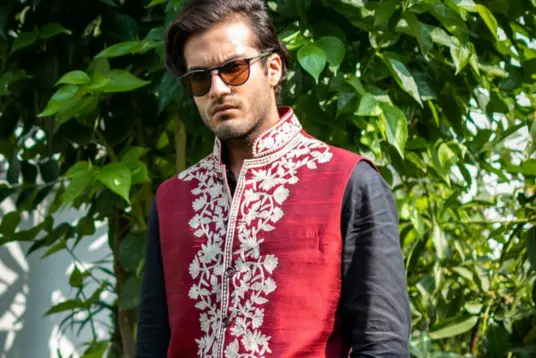 men wearing maroon nehru jacket outside