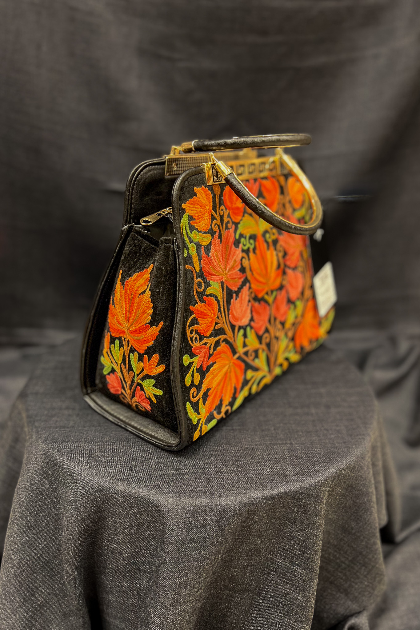 Introducing our stunning Kashmiri Aari Embroidered Women Hand Bag, the perfect accessory to elevate any outfit. Crafted with precision and care, this bag is a testament to the rich cultural heritage of Kashmir. This lightweight handbag with its spacious interior is perfect for daily use or special occasions. The floral Aari work pattern adds a touch of elegance and sophistication. The two handles give you a comfortable grip to hold and it is easy to carry. Our Kashmiri Aari Embroidered Women Hand Bag is the perfect accessory to complete your look. Buy yours today and add a touch of luxury and style to your wardrobe!